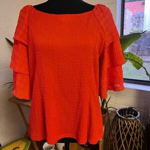 Red shirt with fun cascading sleeves.